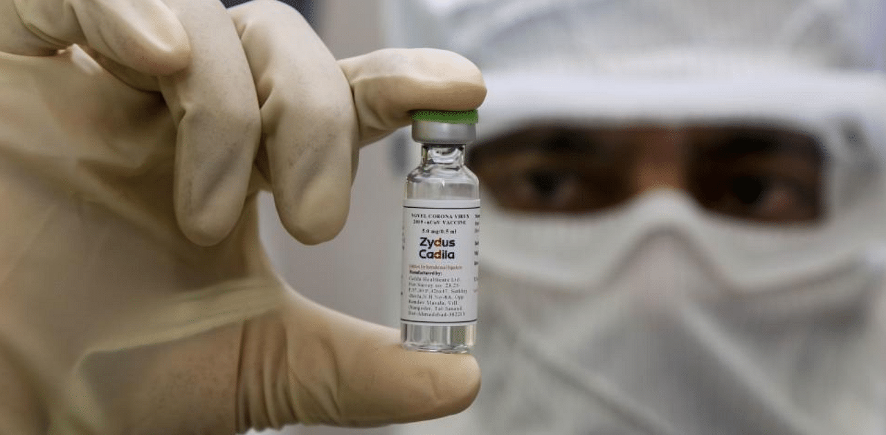  a pharmaceutics worker shows a shot of a vaccine developed by Zydus Cadila to treat the Covid-19 coronavirus. Credit: AFP File Photo