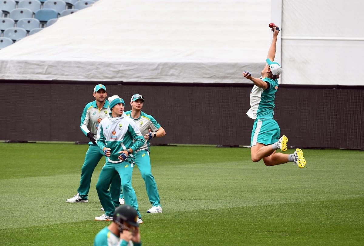 Australia's Cameron Green (R) attempts to take a catch during a training session ahead of the second cricket Test match against India, in Melbourne. Credit: AFP. 