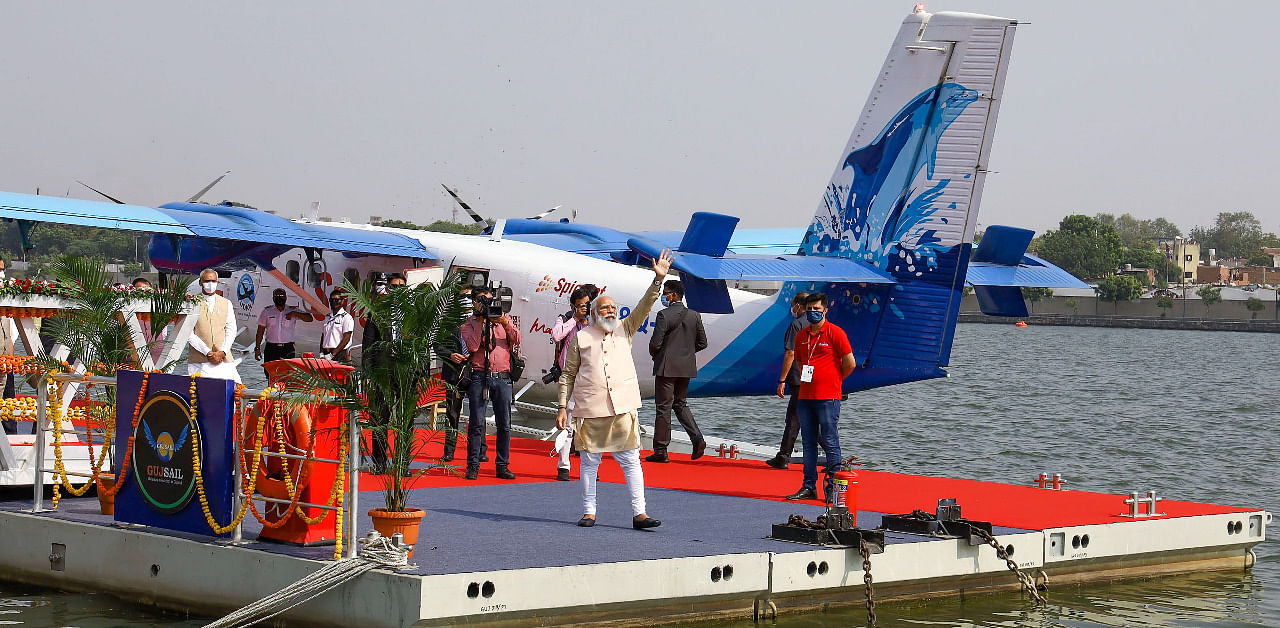 Prime Minister Narendra Modi waves to his supporters after he arrived from Kevadia via India’s first seaplane, at Sabarmati Riverfront in Ahmedabad. Credit: PTI Photo