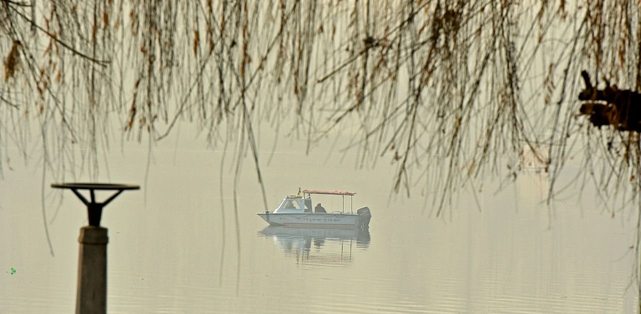A police boat is seen in the waters of Dal Lake. Credit: AFP Photo
