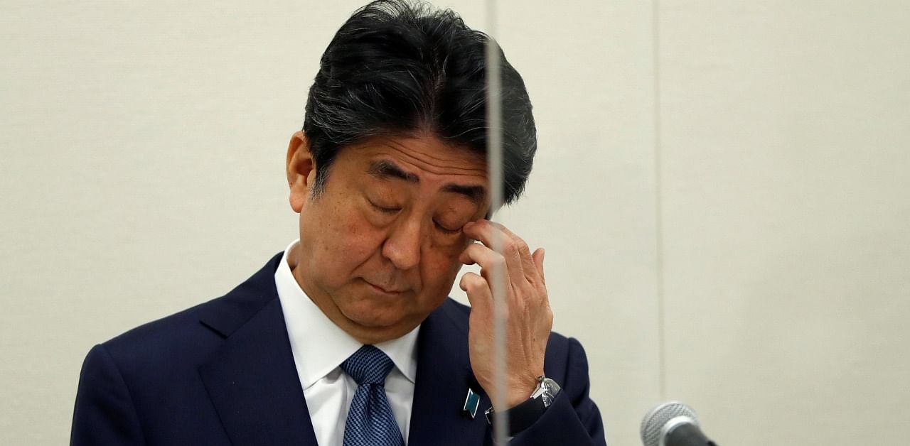 Former Japanese Prime Minister Shinzo Abe, embroiled in a case against his secretary over unreported political funds, gestures as he attends a news conference in Tokyo. Credit: Reuters Photo