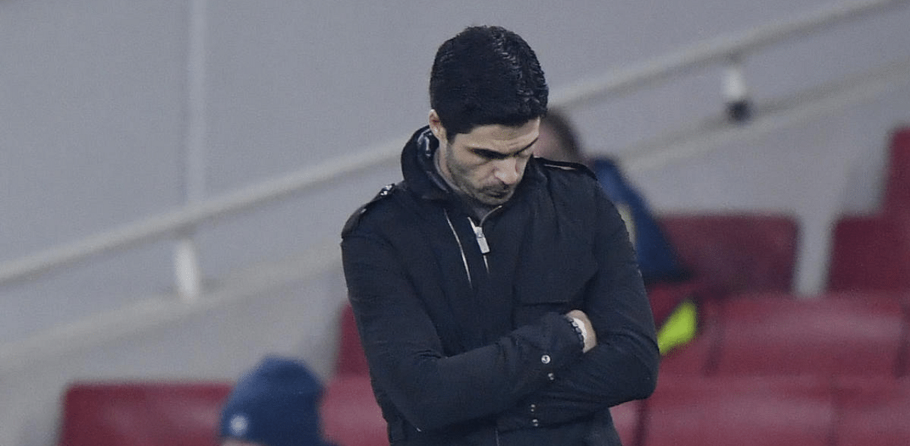 A dejected Mikel Arteta looks down as his Arsenal side conceded a fourth goal against Manchester City in the League Cup quarterfinals on Thursday. Credit: Reuters