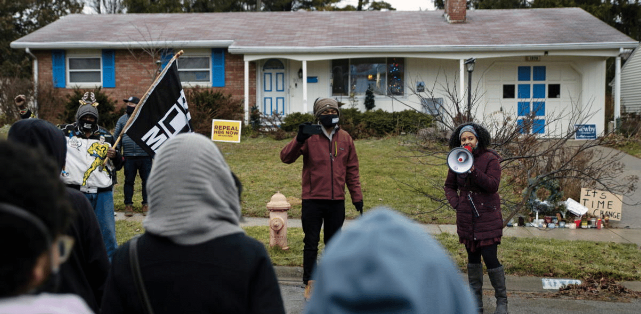 Protesters gather outside the home where Andre Maurice Hill, 47, was killed in Columbus, Ohio, US. Credit: Reuters