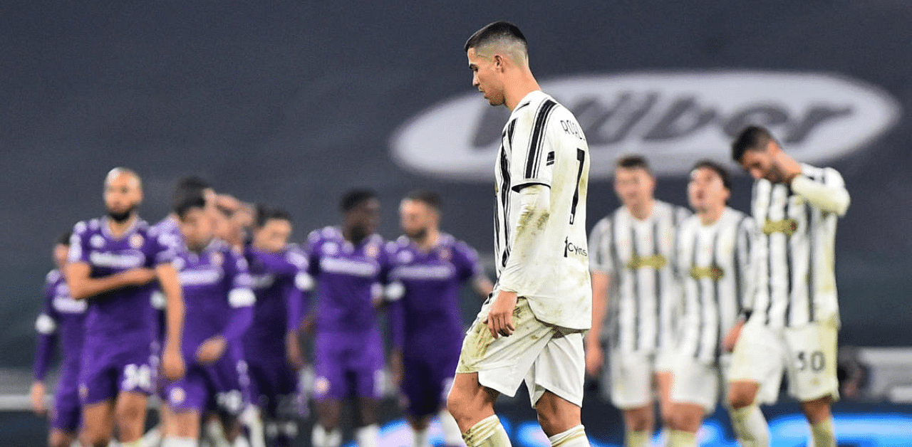 Juventus' Cristiano Ronaldo looks dejected after Fiorentina celebrate their second goal from Alex Sandro's own goal. Credit: Reuters