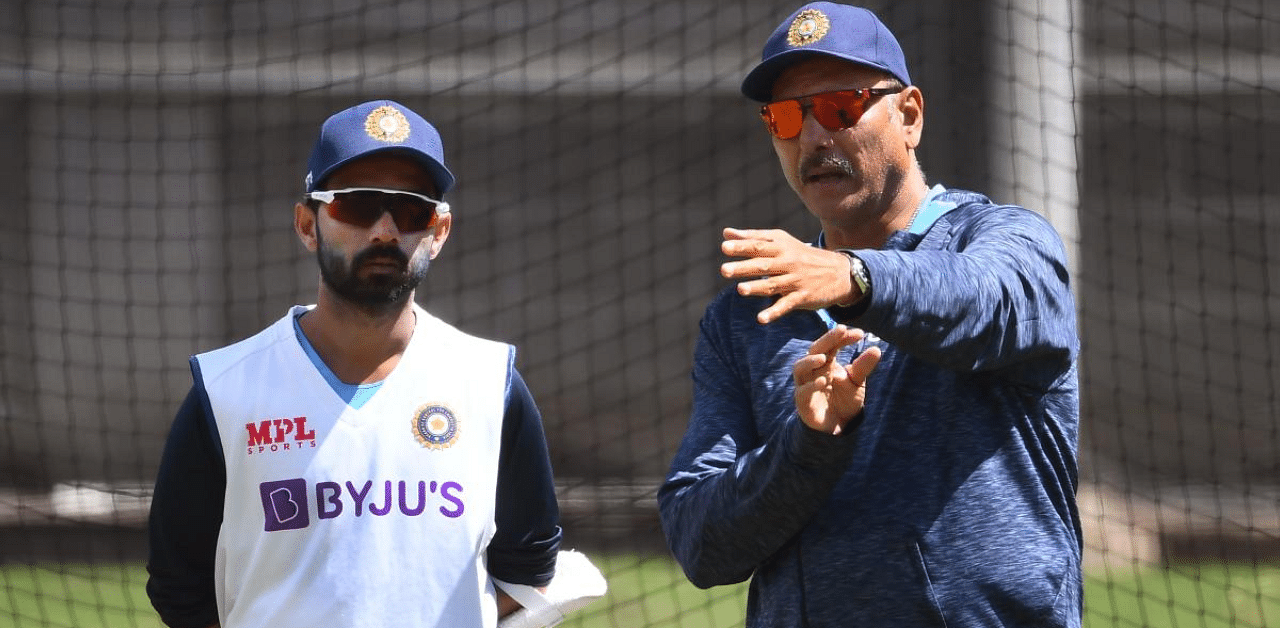 India's captain Ajinkya Rahane (L) chats with coach Ravi Shastri (R) during a training session ahead of the second cricket Test match against Australia. Credit: AFP Photo