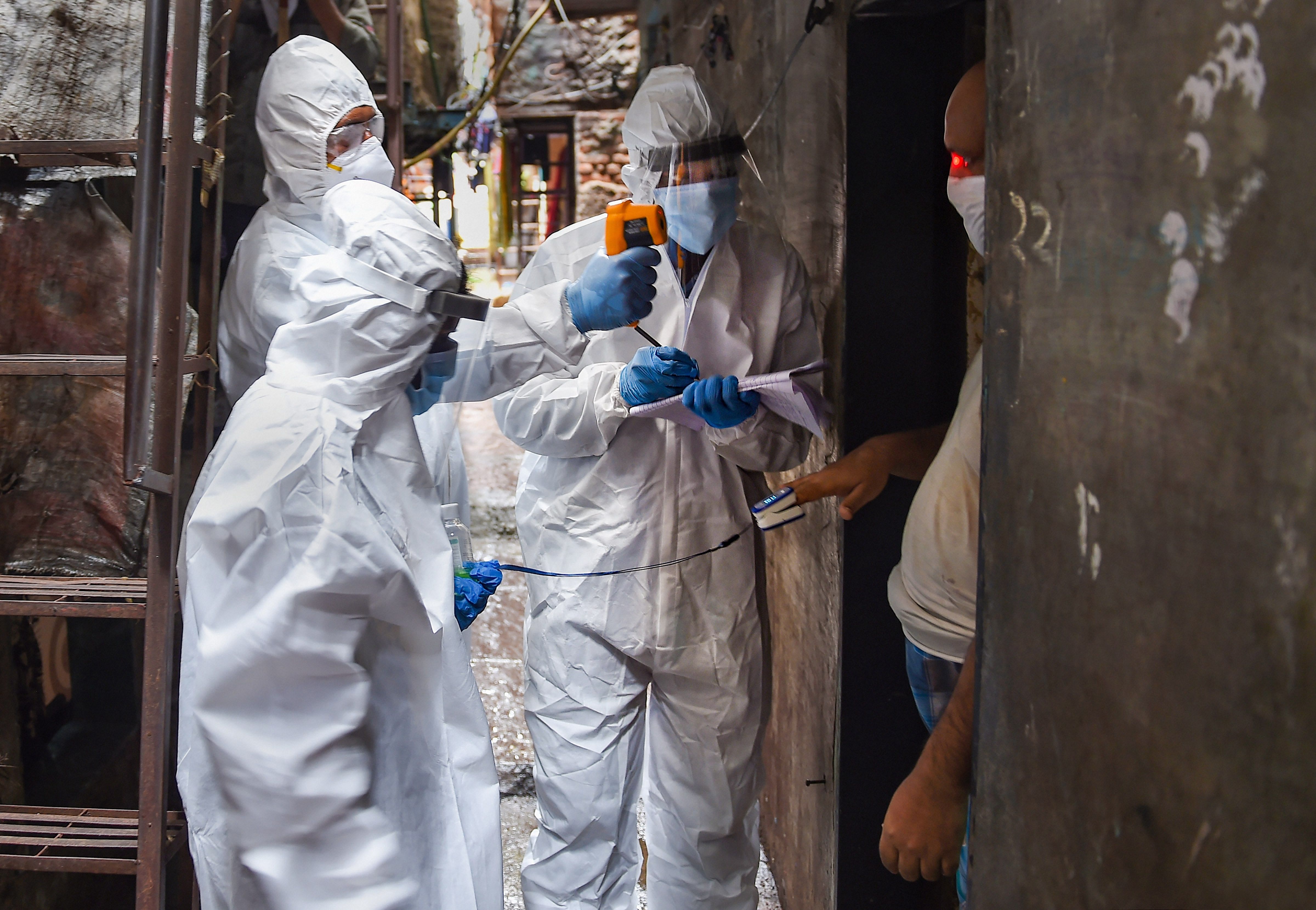 Health workers wearing PPE kits conduct door-to-door medical check-up of the residents of Dharavi slum, amid Covid-19 pandemic in Mumbai, Thursday, July 9, 2020. Credit: PTI File Photo