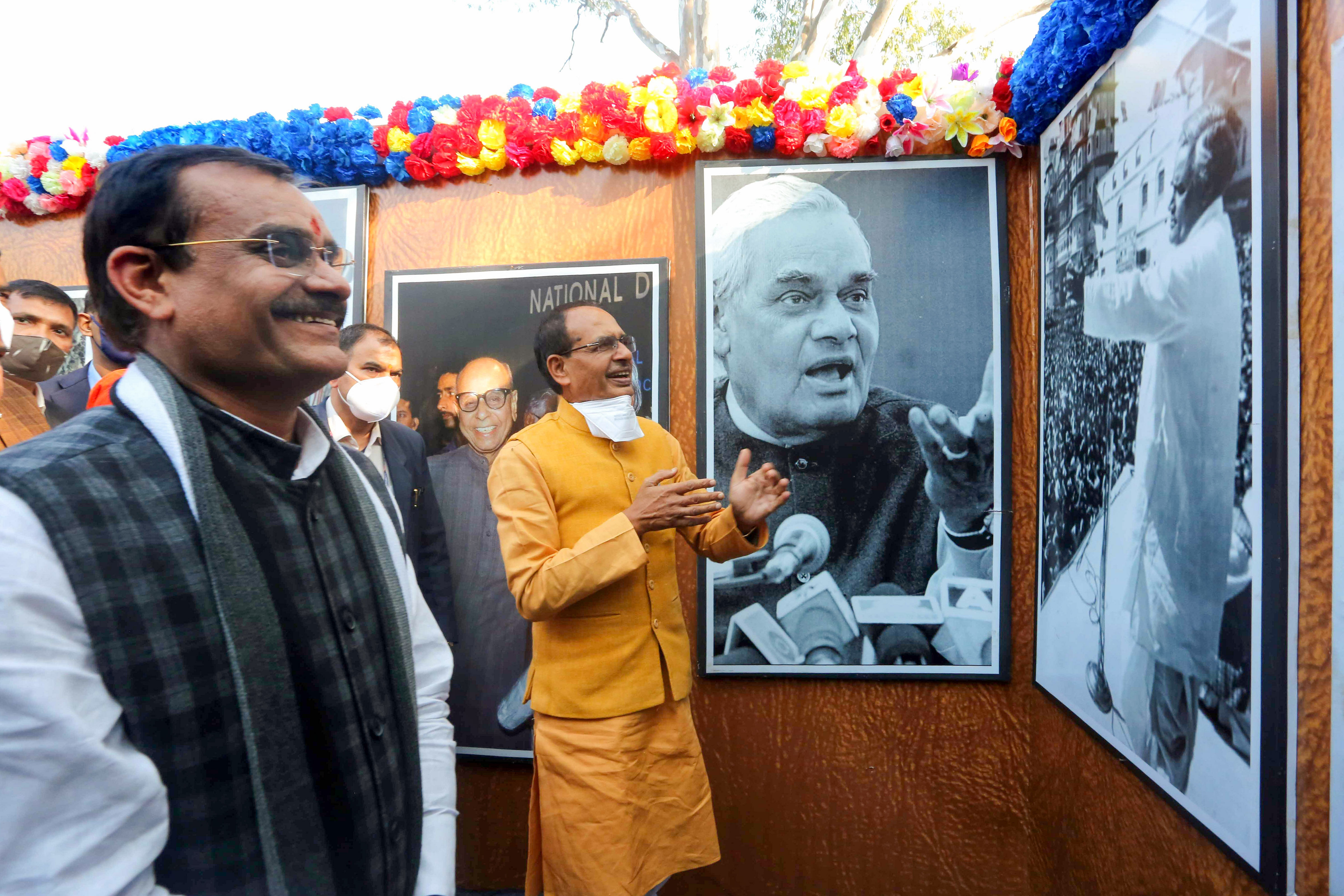Madhya Pradesh Chief Minister Shivraj Singh Chouhan with BJP State President VD Sharma goes around a photo exhibition on former Prime Minister Atal Bihari Vajpayee after unveiling his statue on his birth anniversary, in Bhopal, Friday, Dec. 25, 2020. Credit: PTI Photo