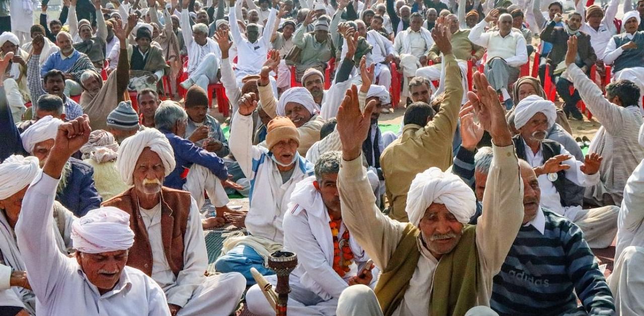 Farmers shout slogans during a protest against new farm laws, in Rohtak. Credit: PTI.
