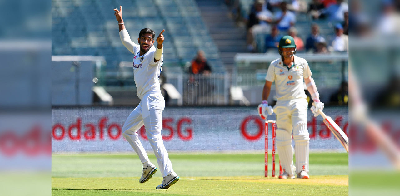 Jasprit Bumrah (L) appeals successfully for the wicket of Australia's Joe Burns (R) on the first day of the second cricket Test match between Australia and India played at the MCG. Credit: AFP