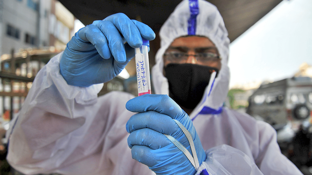 A medic collects swab sample for the Covid-19 test at a free coronavirus testing centre. Credit: DH Photo