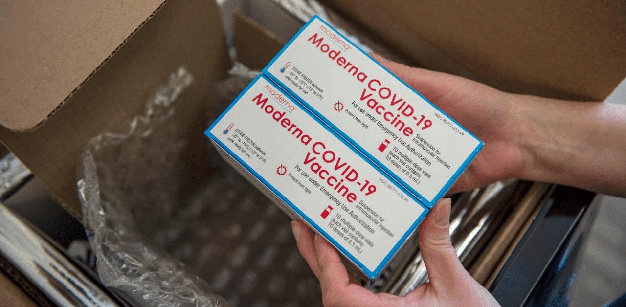 A nurse unpacks a box containing Moderna's Covid-19 vaccine. Credit: AFP