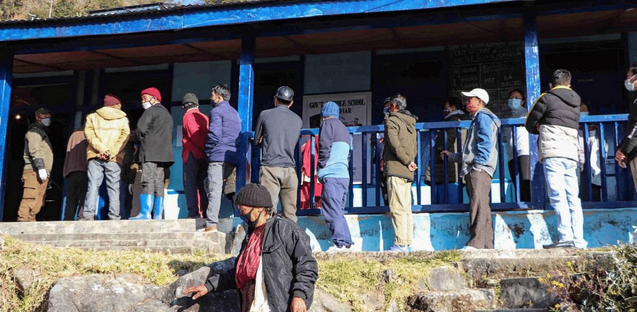 People stand in a queue to cast their vote in Panchayat Polls 2020 in Tawang. Credit: PTI