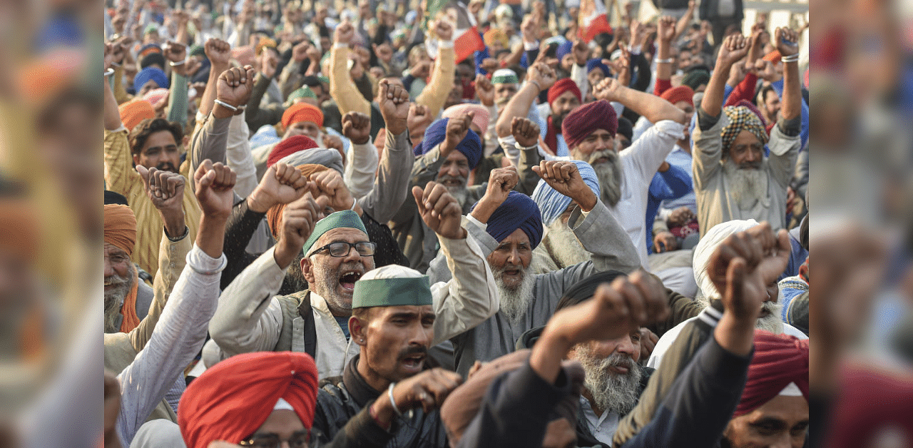  Farmers raise slogans during their protest against the Center's new farm laws at Ghazipur border in New Delhi, Thursday, Dec. 24, 2020. Credit: PTI Photo