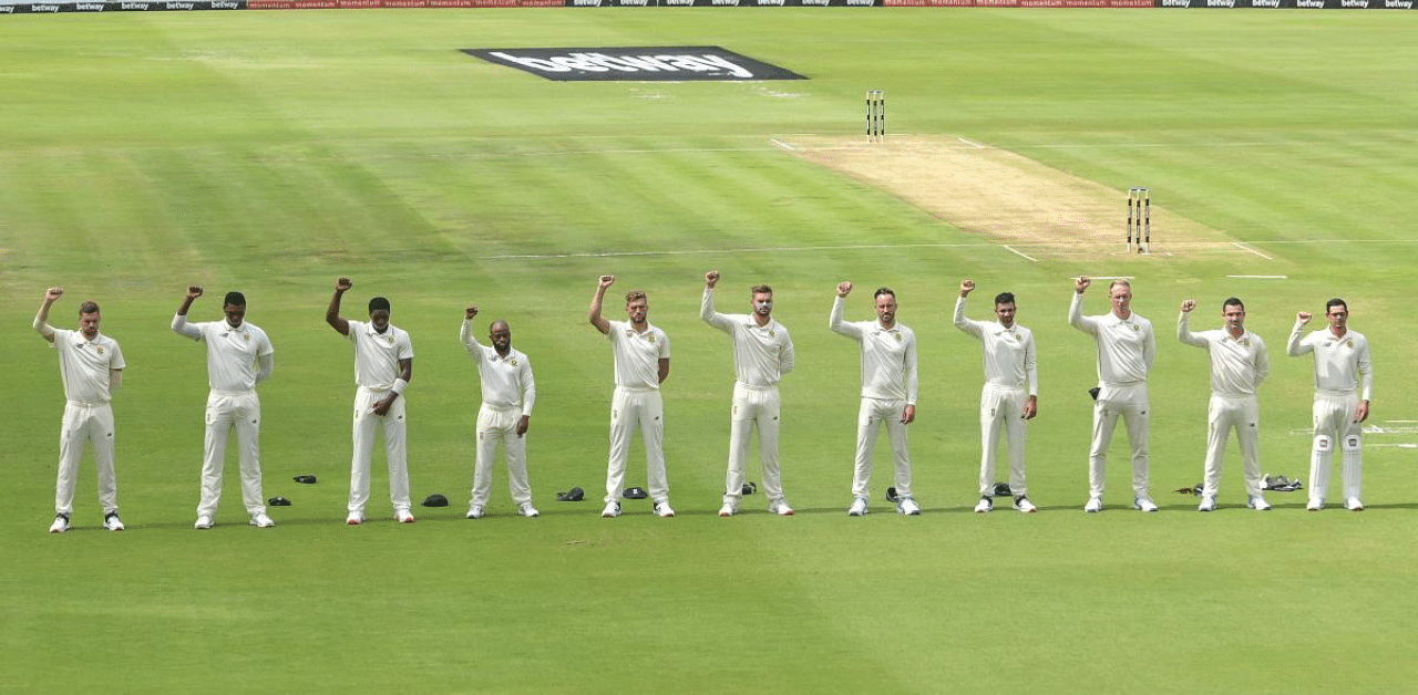 South African cricket players raise their fists in the air in solidarity with the Black Lives Matter (BLM) movement during the first day of the first Test cricket match between South Africa and Sri Lanka at SuperSport Park in Centurion. Credit: AFP Photo