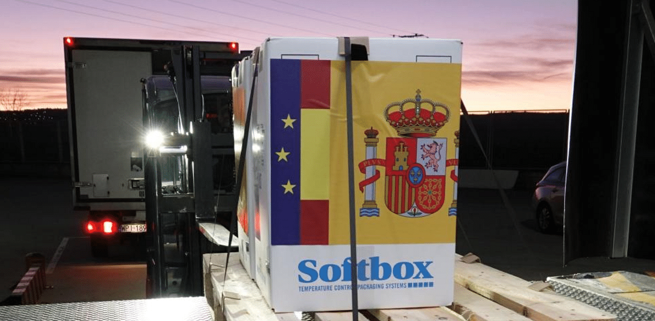 In this handout image released by the Spanish Health Ministry a first batch of the Pfizer-BioNTech Covid-19 vaccine is downloaded from a refrigerated truck and stored in an undisclosed warehouse in Guadalajara, upon its arrival from Belgium on December 26, 2020. Credit: AFP 