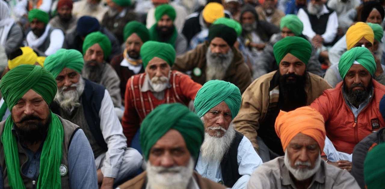 Farmers take part in a protest against the central government's recent agricultural reforms as they block a highway at Tikri border in New Delhi. Credit: AFP Photo