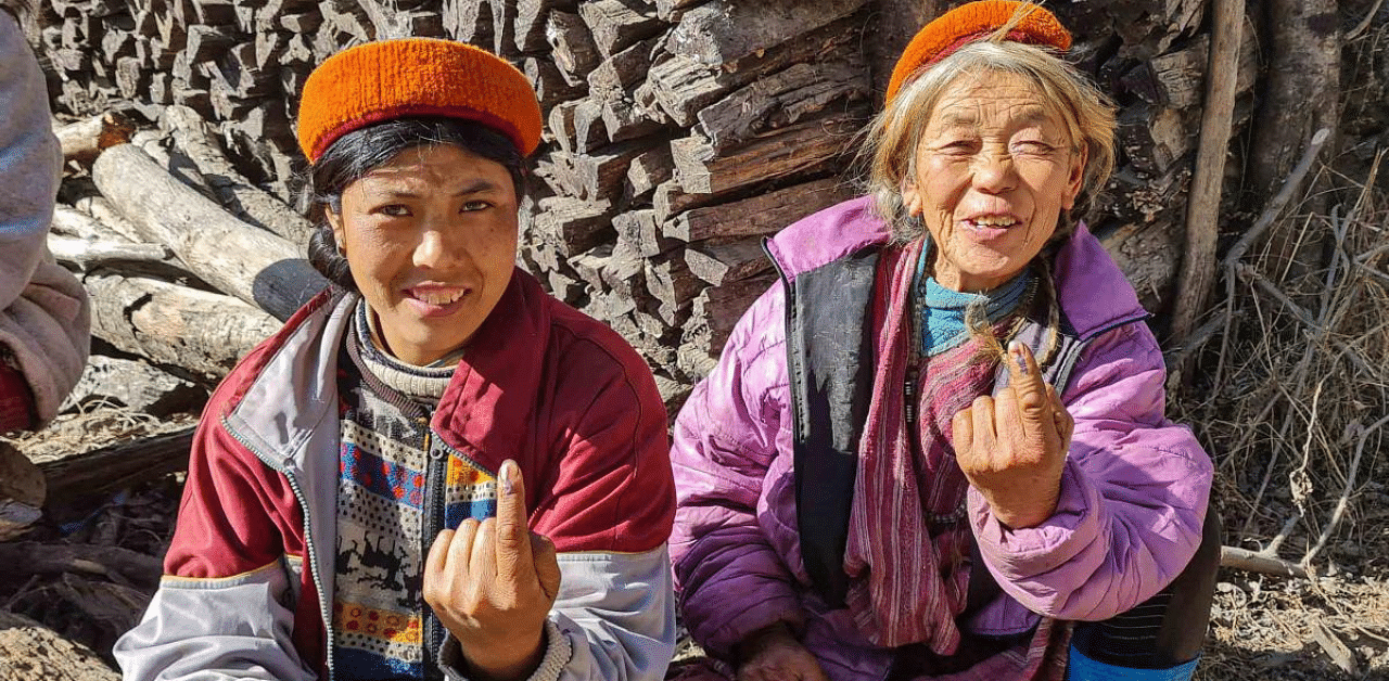 Voters show their fingers marked with indelible ink after casting their votes during the Panchayat Polls 2020 in Tawang. Credit: PTI Photo