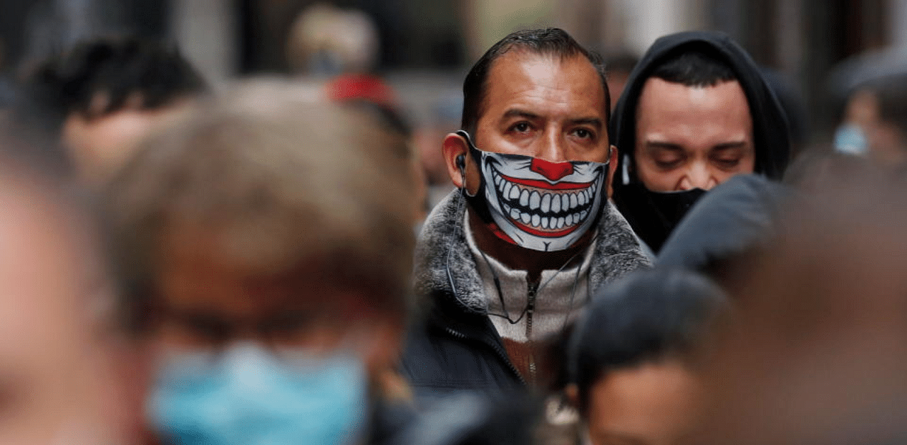 People wearing protective masks wait in line to buy lottery tickets of the Spanish Christmas Lottery "El Gordo", amid the coronavirus disease (COVID-19) outbreak, in Madrid, Spain December 21, 2020. Credit: Reuters Photo
