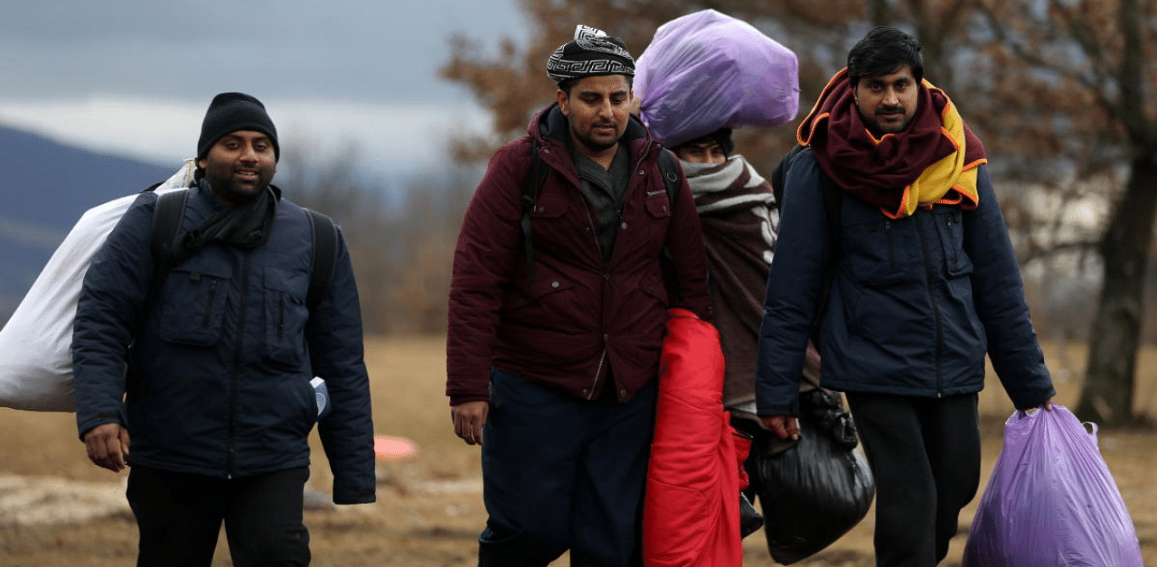 Migrants leave the burned migrant center "Lipa" in Bihac. Credit: Reuters Photo