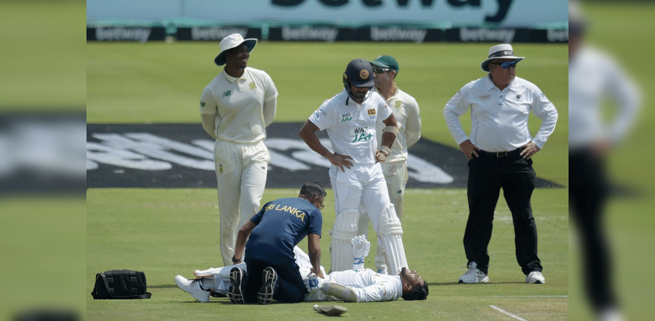 Sri Lanka's Dhananjaya de Silva (bottom) receives medical attention during the first day of the first Test cricket match between South Africa and Sri Lanka at SuperSport Park in Centurion on December 26, 2020. Credit: AFP Photo