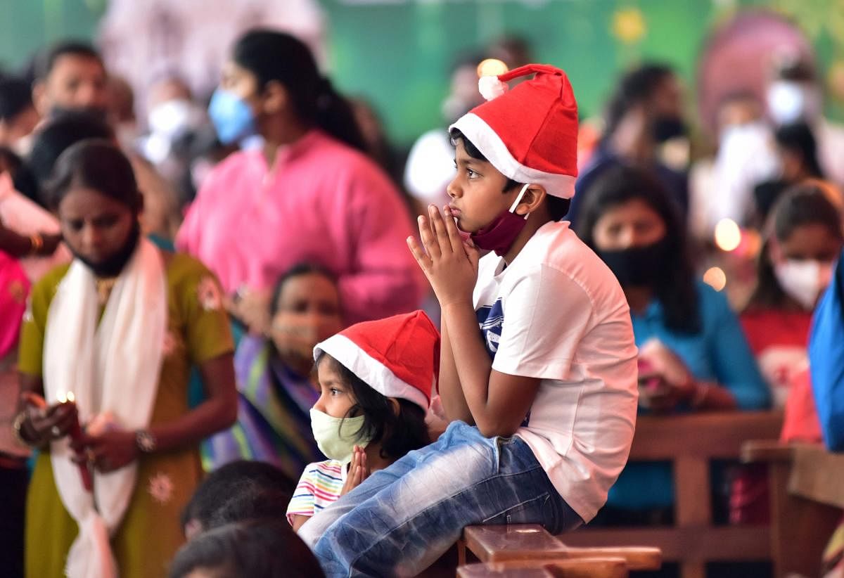 Children pray at St Mary's Basilica, Shivajinagar, Bengaluru, on Christmas Day. DH PHOTO/IRSHAD MAHAMMAD