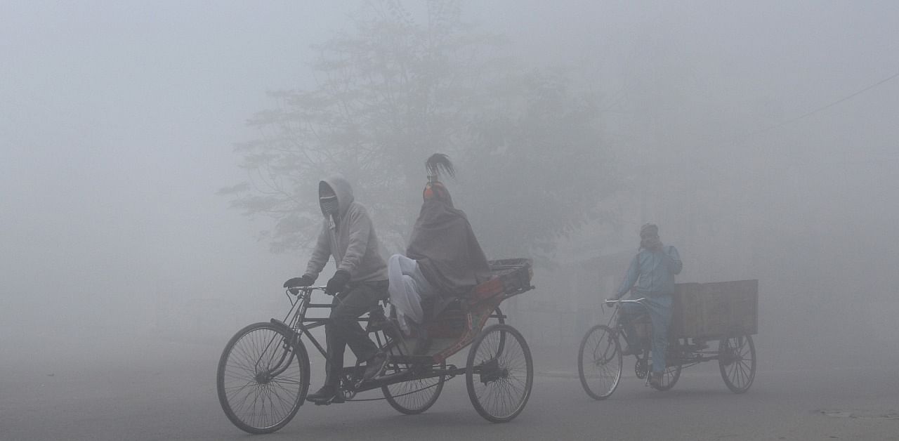 A man pulls his rickshaw amid dense fog, in Jalandhar. Credit: PTI Photo