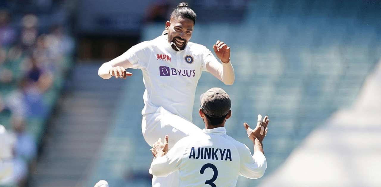 Mohammed Siraj celebrates with Ajinkya Rahane after dismissing Australia's Marnus Labuschagne during day one of the second test match between Australia and India at The MCG, Melbourne. Credit: Reuters. 