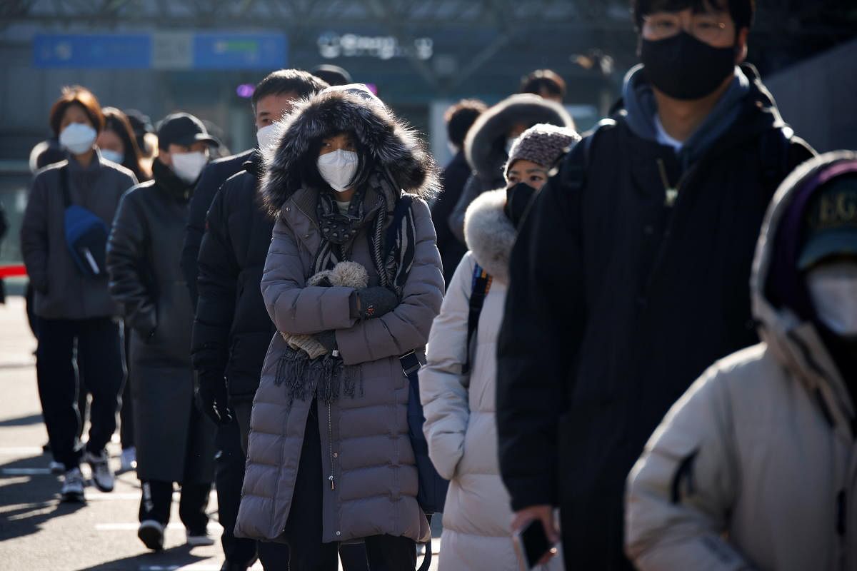People wait in a line to undergo coronavirus disease (COVID-19) test at a coronavirus testing site which is temporarily set up in front of a railway station on Christmas day in Seoul, South Korea. Credit: Reuters. 