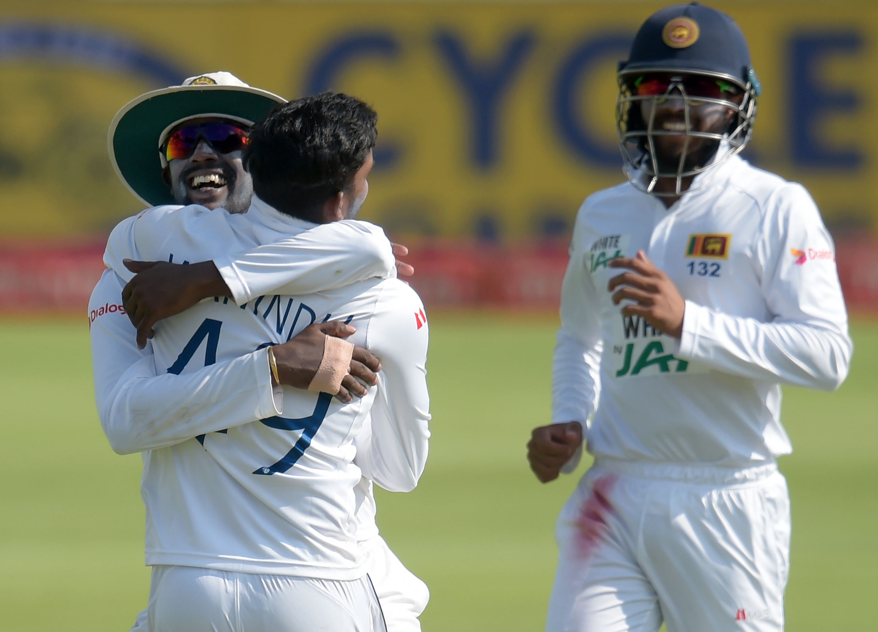   Sri Lanka's Wanindu Hasaranga (C) celebrates with teammates after the dismissal of unseen South Africa's captain Quinton de Kock during the second day of the first Test cricket match between South Africa and Sri Lanka at SuperSport Park in Centurion on December 27, 2020. Credit: AFP Photo