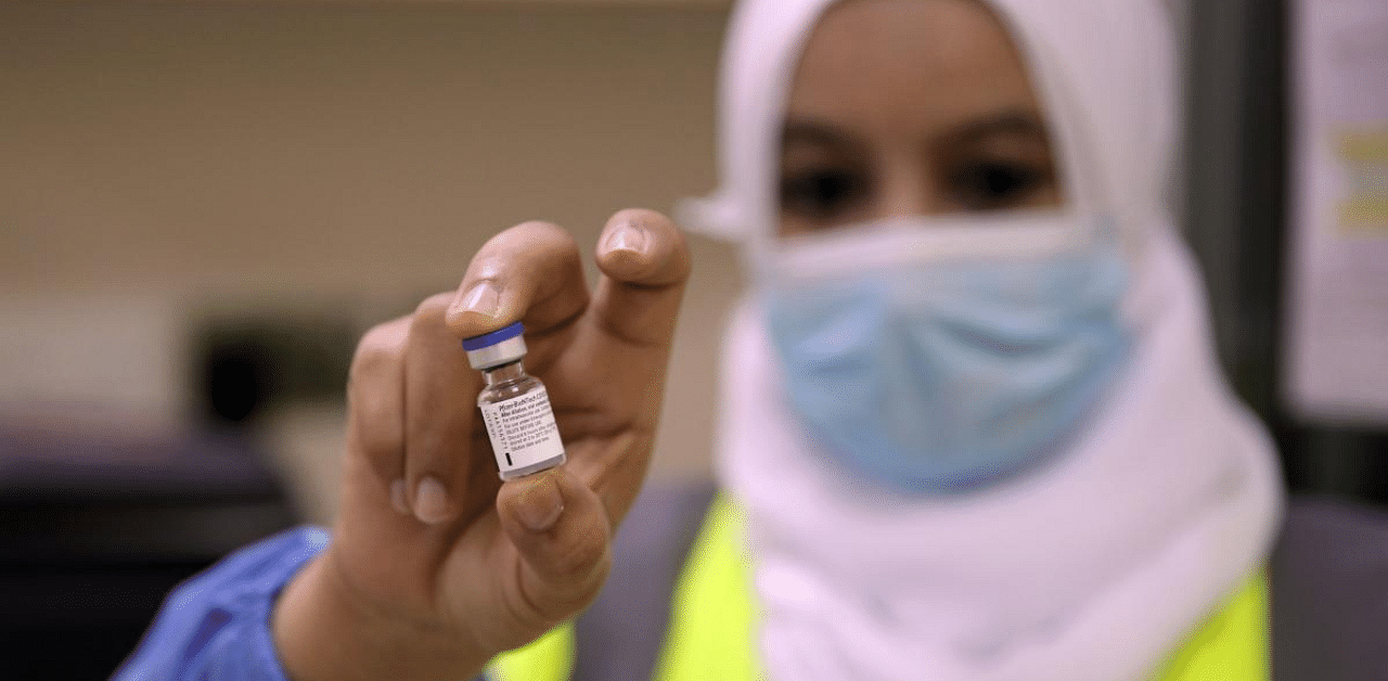 A healthcare worker prepares to administer the Pfizer-BioNTech Covid-19 vaccine in the Omani capital Muscat. Credit: AFP Photo