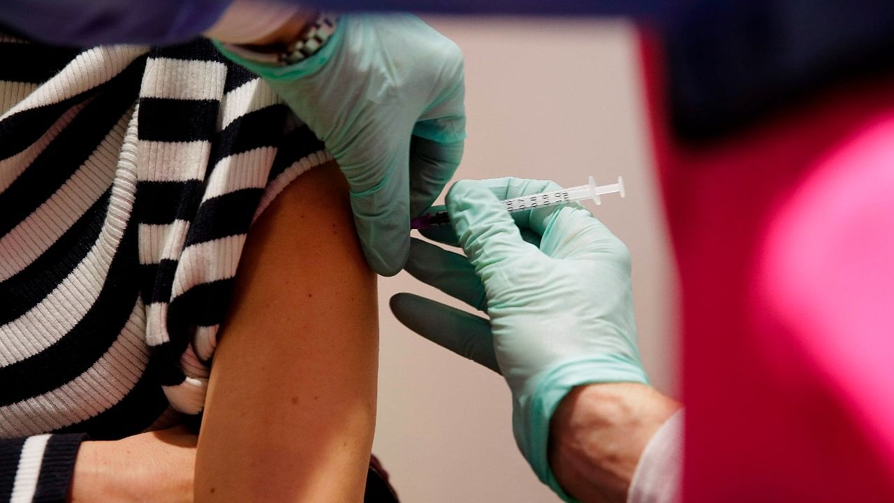 Sabine Schimmel receives the Pfizer-Biontech Covid-19 corona virus vaccine at the Arena Treptow vaccine center in Berlin. Credit: AFP Photo