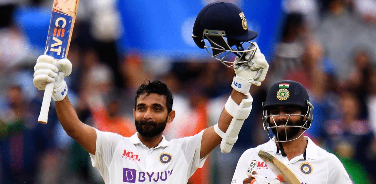 Ajinkya Rahane (L) celebrates scoring his century (100 runs) as teammate Ravi Jadeja (R) looks on during the second day of the second cricket Test match between Australia and India at the MCG in Melbourne. Credit: AFP. 