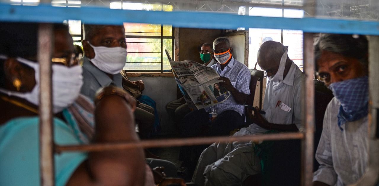 Passengers look out from a carriage of a train from the Mass Rapid Transit System (MRTS) which resumed service, following a nationwide lockdown imposed as a preventive measure against the spread of the Covid-19 in Chennai. Credit: AFP Photo