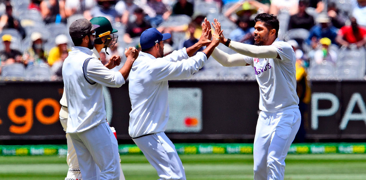 India's Umesh Yadav (R) celebrates the wicket of Australia's batsman Joe Burns (2nd L) with teammates. Credit: AFP Photo