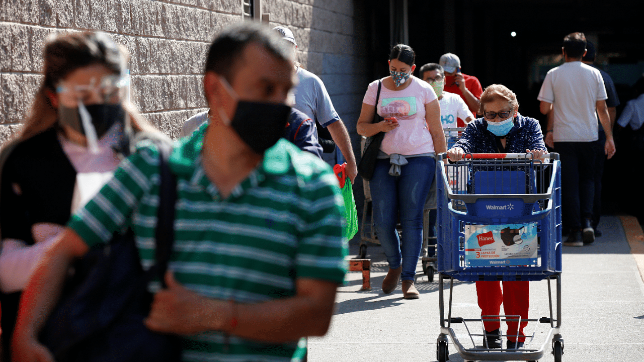 People queue to enter a supermarket for last minute Christmas shopping, as the coronavirus disease (Covid-19) outbreak continues. Credit: Reuters Photo