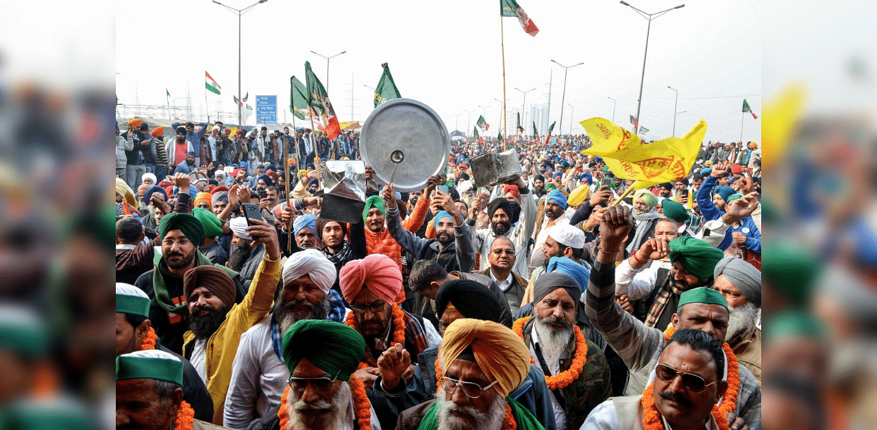 Farmers beat utensils during a protest against the central government's recent agricultural reforms as India's Prime Minister Narendra Modi addresses the nation on the monthly radio programme 'Mann Ki Baat', in Ghazipur along the Delhi-Uttar Pradesh state border, on December 27, 2020. Credit: AFP Photo