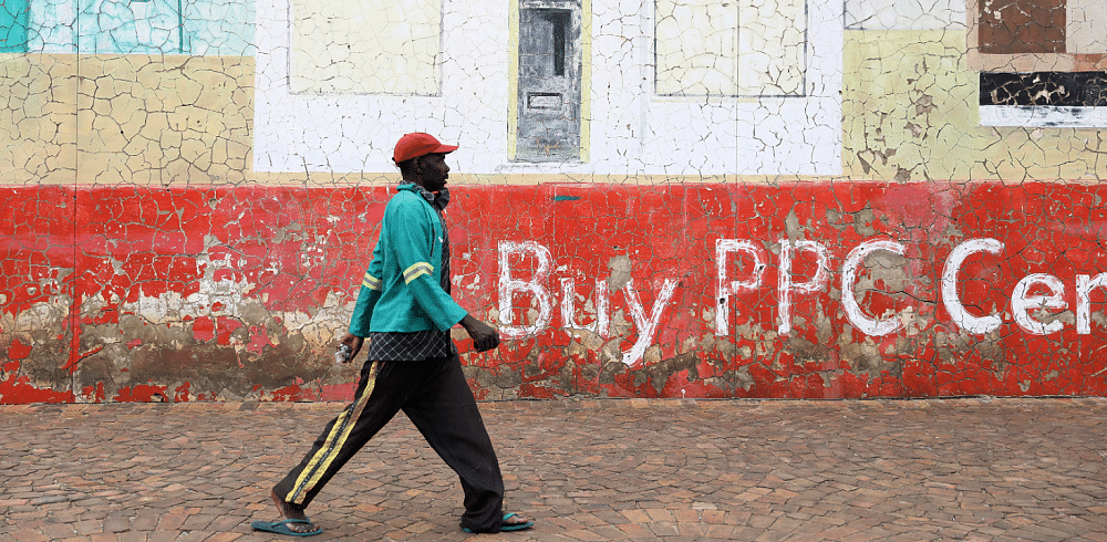 A man, not wearing a face mask, walks beneath a mural depicting a hospital, amid the coronavirus disease outbreak, in Soweto, South Africa. Credit: Reuters Photo