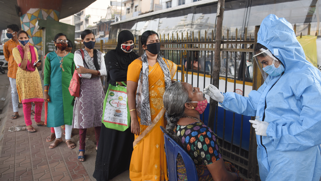 Medical Staff collecting nasal swab from public for coronavirus test. Credit: DH Photo