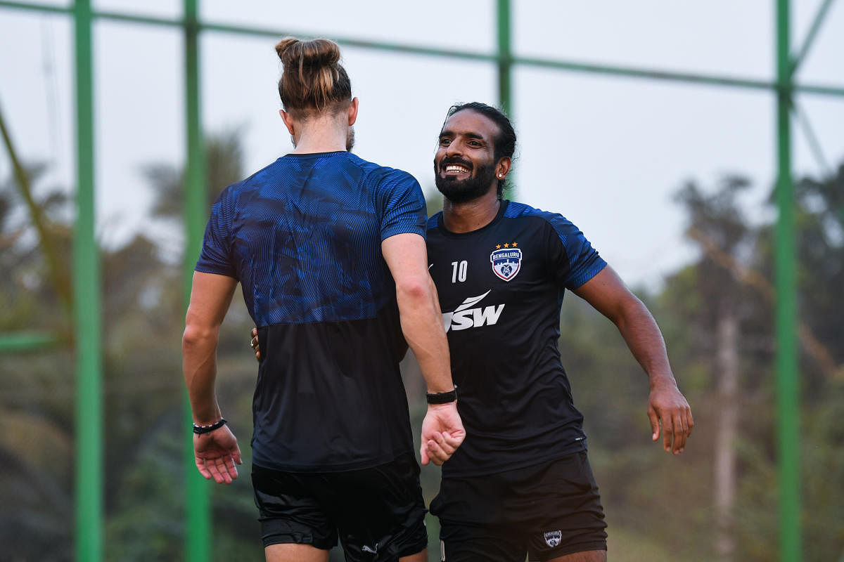Bengaluru FC's Harmanjot Khabra (right) and Erik Paartalu share a light moment during a training session ahead of their game against Jamshedpur FC on Monday.