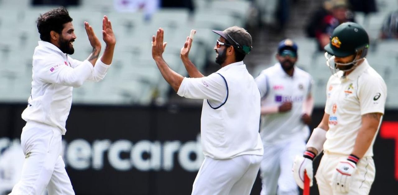 India's Ravi Jadeja (L) and Ajinkya Rahane (C) celebrate dismissing Australia's Matthew Wade (R) on the third day of the second cricket Test match between Australia and India at the MCG in Melbourne on December 28, 2020. Credit: AFP Photo