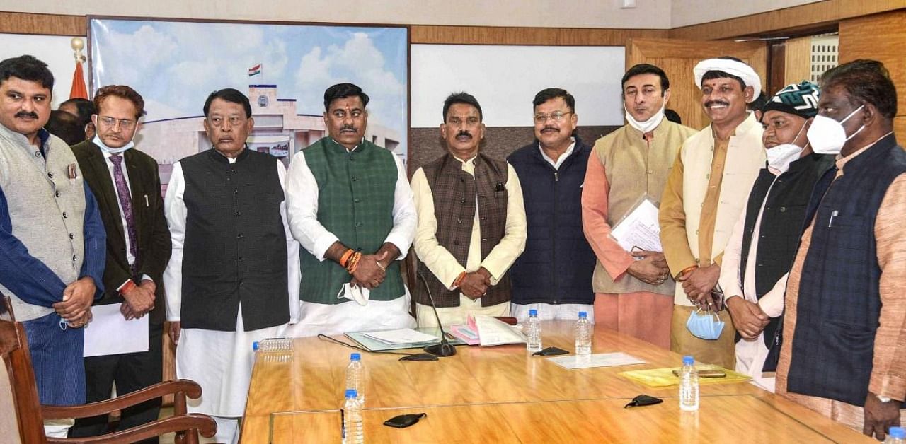 Protem Speaker of the Madhya Pradesh Assembly Rameshwar Sharma with the newly elected MLAs during their oath ceremony, in Bhopal. Credit: PTI.
