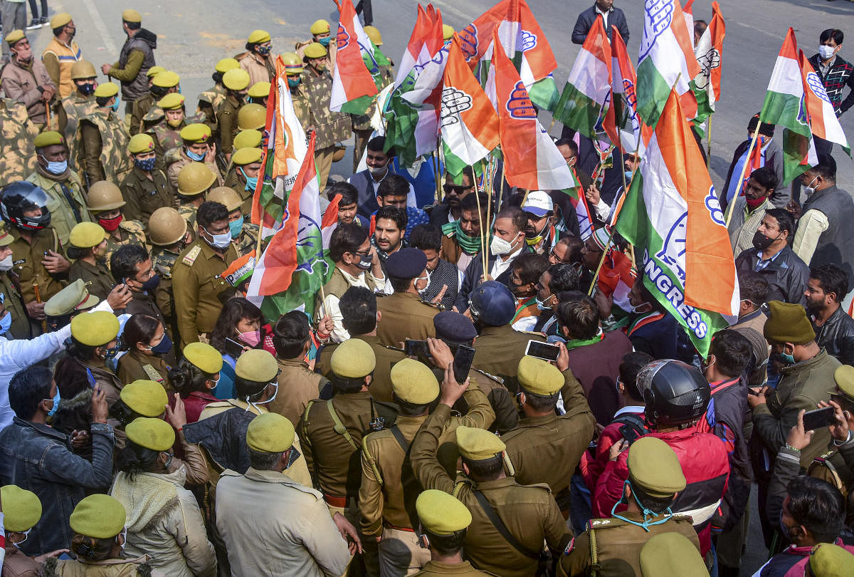 Policemen detain Congress Party workers protesting against the new farm laws during 'Congress Sandesh Yatra,' in front of Anand Bhavan in Prayagraj, Monday, Dec. 28, 2020. Credit: PTI Photo