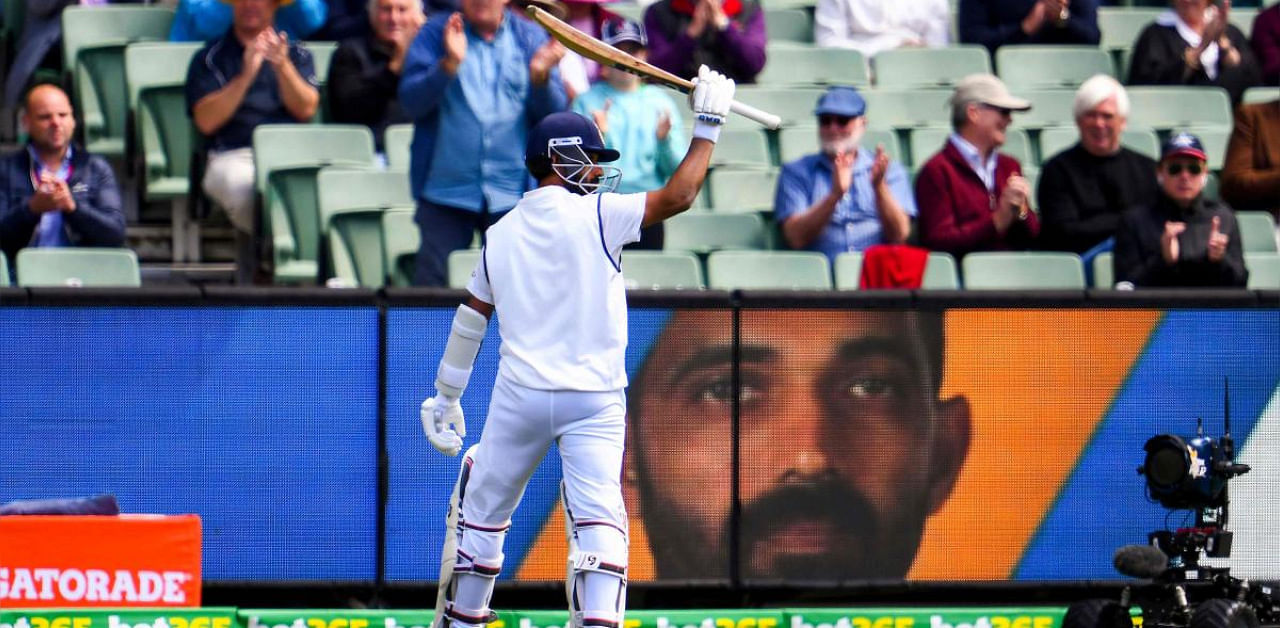 Ajinkya Rahane acknowledges the applause as he walks back to the pavilion after his dismissal on the third day of the second cricket Test match between Australia and India at the MCG in Melbourne. Credit: AFP Photo