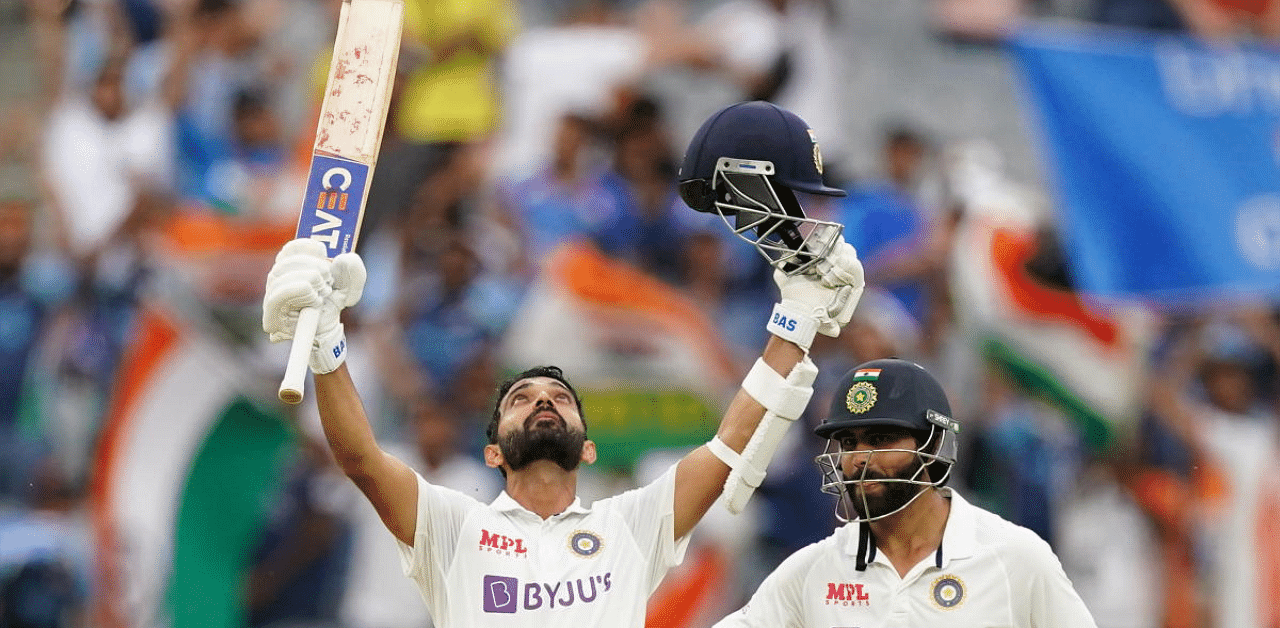 Ajinkya Rahane celebrates after reaching his century as his teammate Ravindra Jadeja looks on during day two of the second test match between Australia and India at The MCG. Credit: Reuters. 
