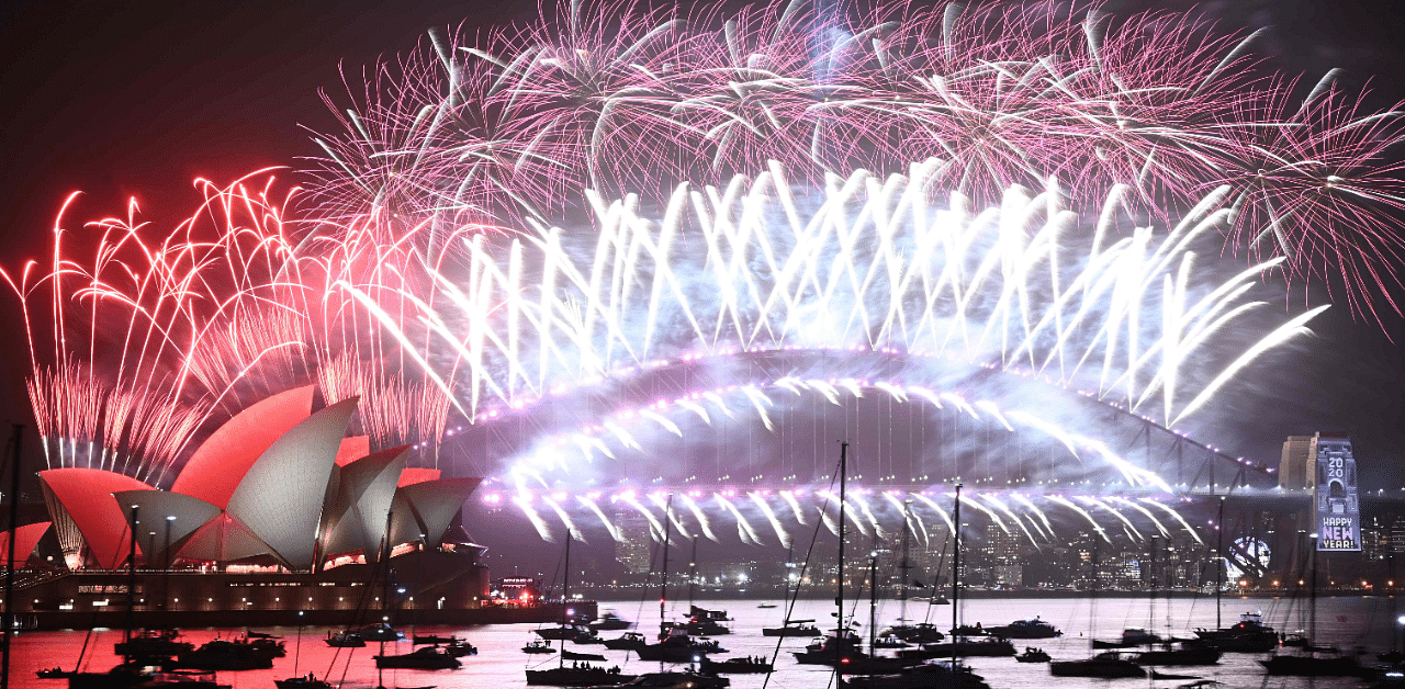 New Year's Eve fireworks erupt over Sydney's iconic Harbour Bridge and Opera House (L) during the fireworks show on January 1, 2020. Credit: AFP