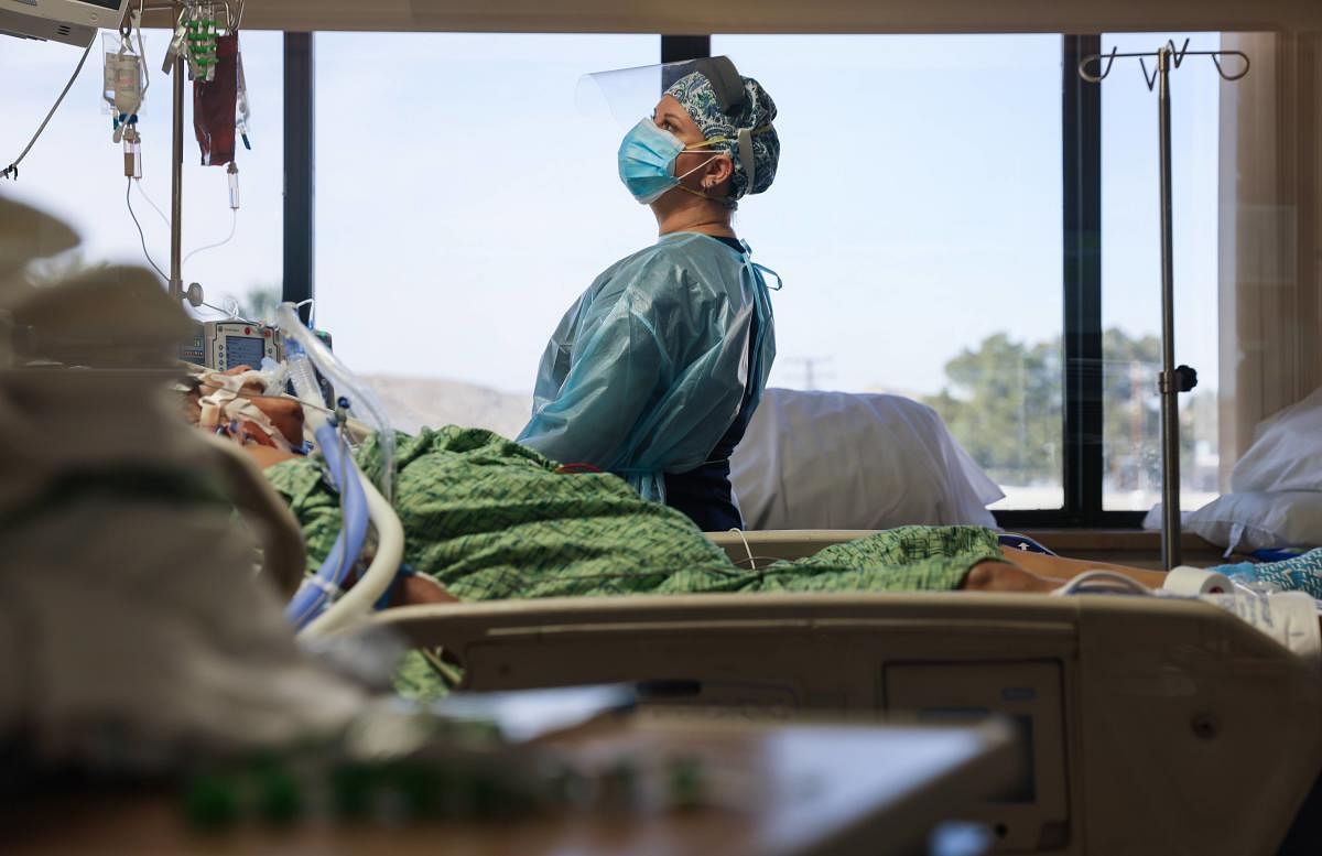 A clinician cares for a coronavirus patient in the Intensive Care Unit (ICU) at Providence St. Mary Medical Center amid a surge in Covid-19 patients in Southern California. Credit: AFP. 