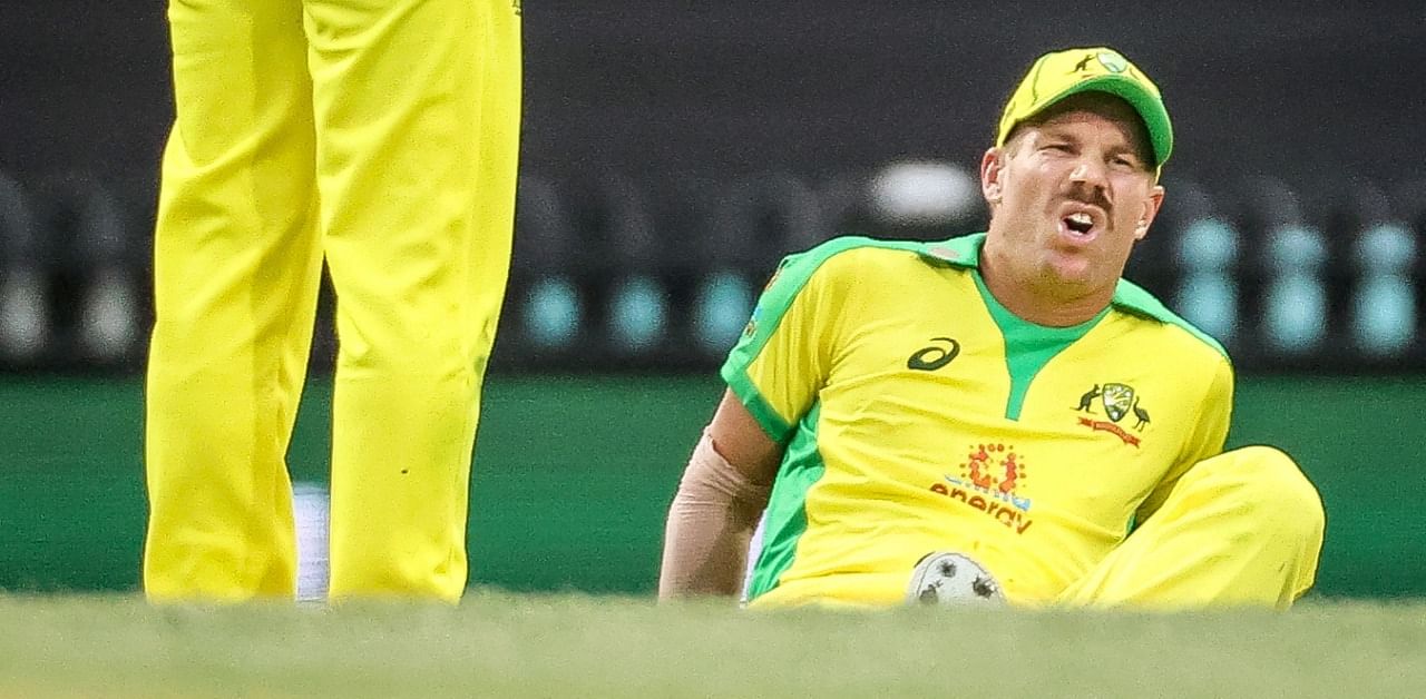 This file photo taken on November 29, 2020 shows Australia's David Warner (R) reacting after he suffered an injury during the one-day cricket match against India at the Sydney Cricket Ground (SCG) in Sydney. Credit: AFP Photo