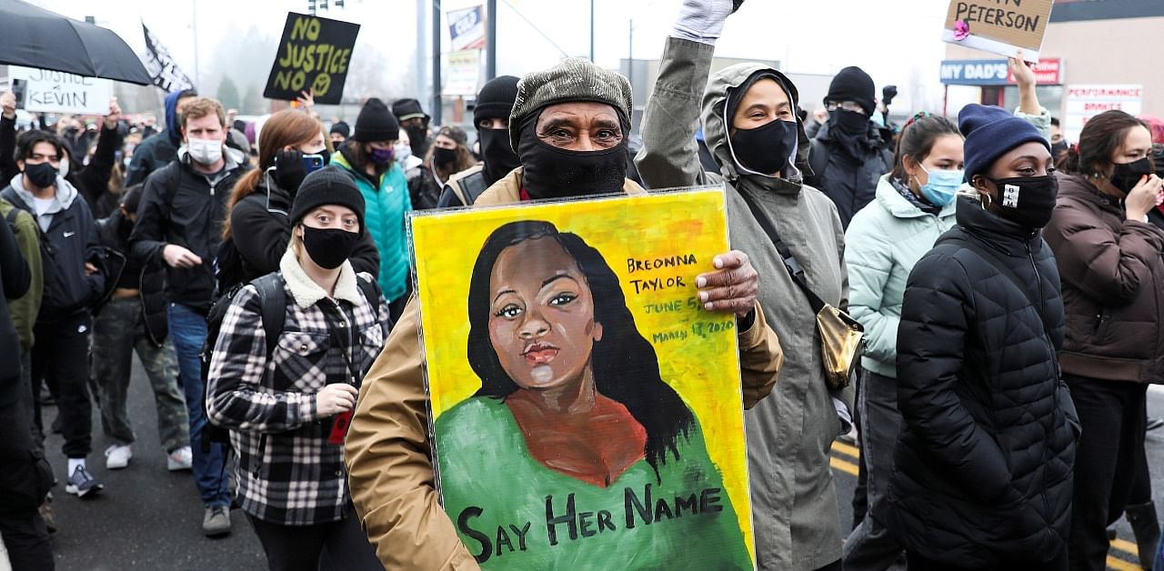 Kent Ford, co-founder of Portland's Black Panther Party carries a painting of Breonna Taylor during a march for Kevin E. Peterson Jr. who was killed by police in Vancouver, Washington. Credit: Reuters Photo