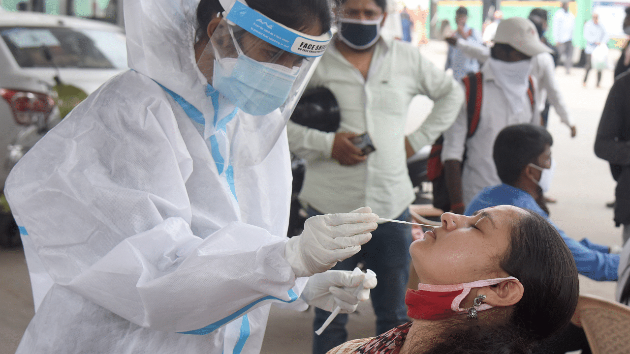 Medical Staff collecting nasal swab from public for Coronavirus test. Credit: DH Photo