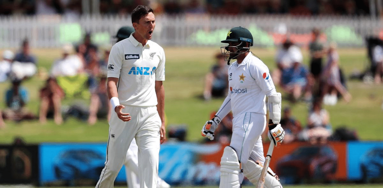 New Zealand’s Trent Boult (L) celebrates the wicket of Pakistan’s Abid Ali (R) during the fourth day of the first cricket Test match between New Zealand and Pakistan at the Bay Oval in Mount Maunganui. Credit: AFP